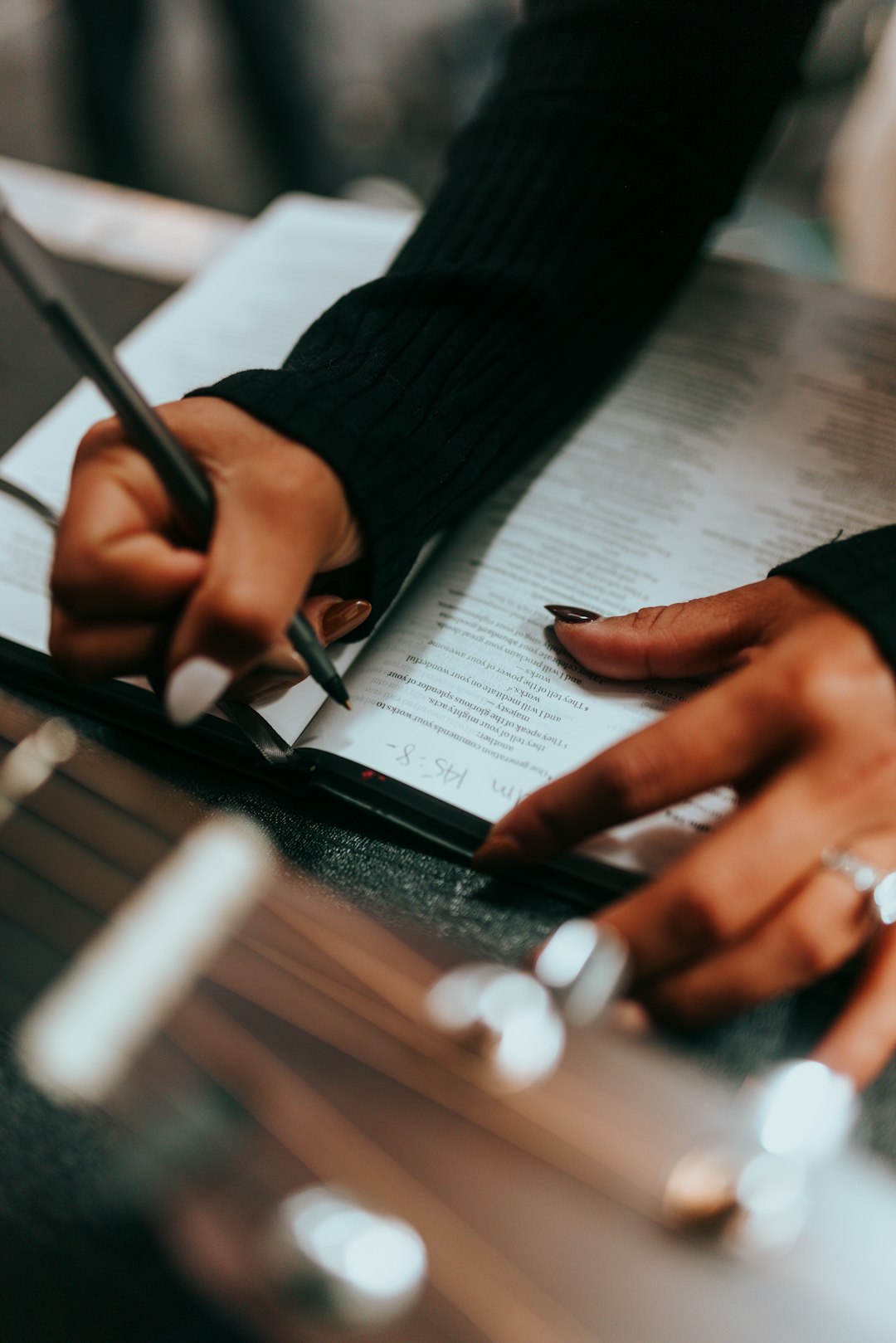 a-person-writing-on-a-piece-of-paper-with-a-pen-3kh93vy7ibc